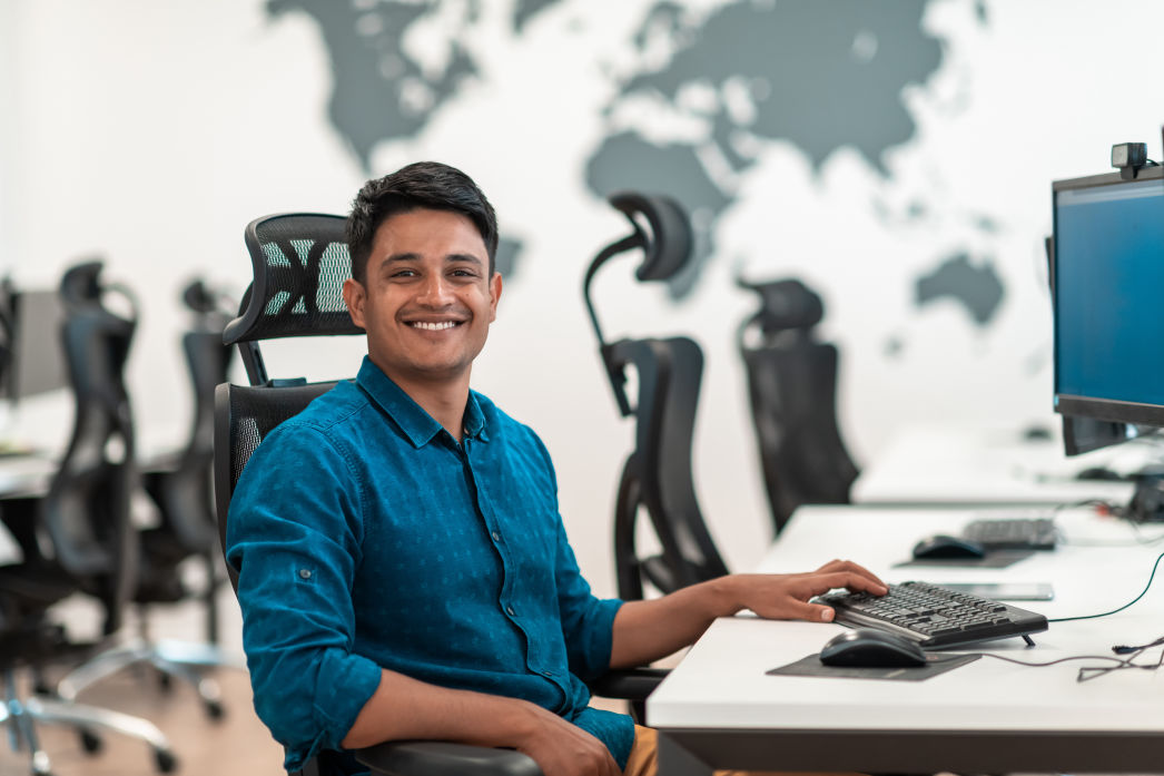 Person sitting at desk smiling 