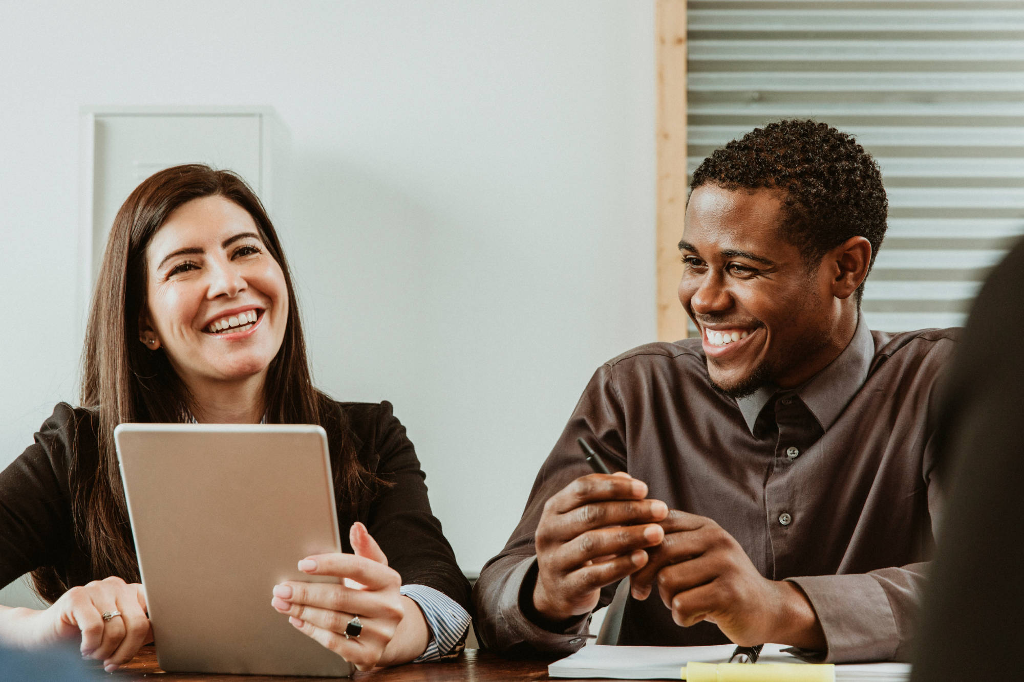 A man and a woman sitting at a meeting table