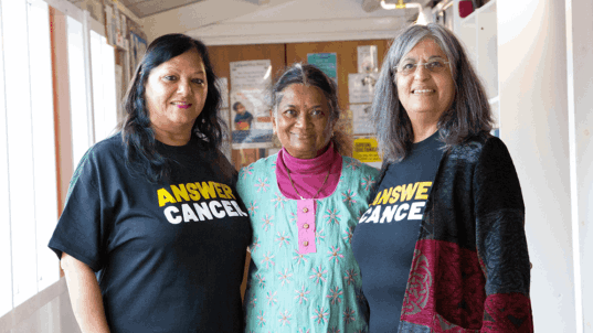 3 women - 2 are wearing Answer Cancer t-shirts 