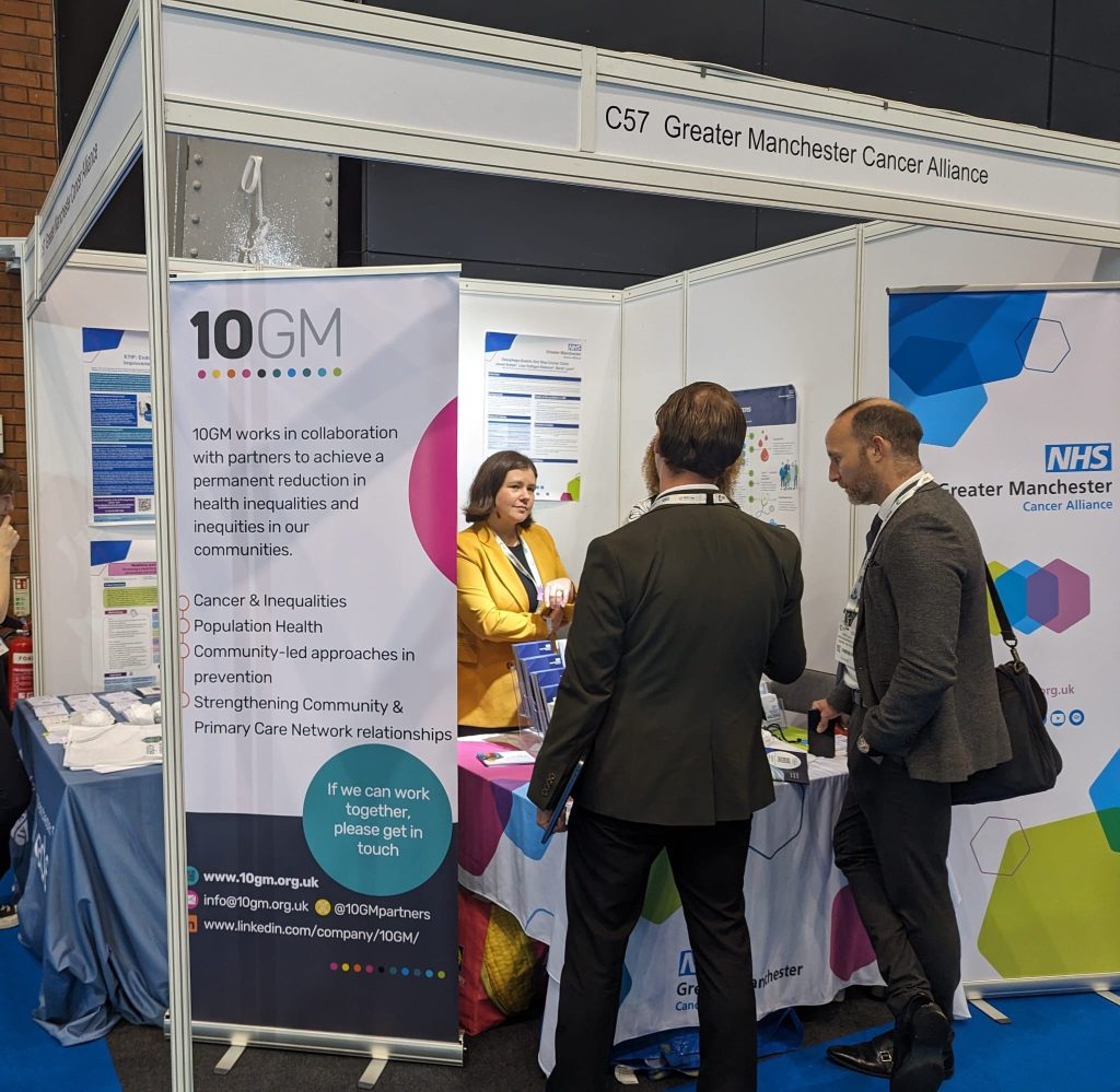 Emma talking to two men at an exhibition stand